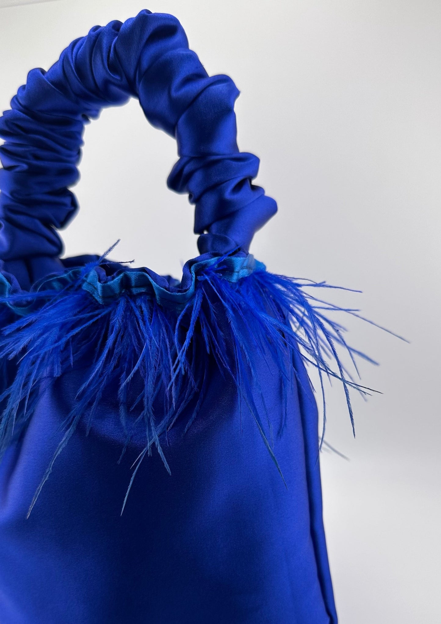 <tc>Royal Blue Satin Scrunchie Bag with Feathers</tc>